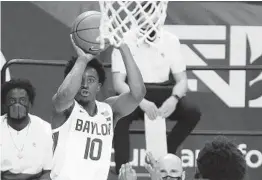  ?? JERRY LARSON AP ?? Baylor sophomore guard Adam Flagler shoots a 3-pointer against Iowa State in the second half Tuesday. He finished with a team-high 22 points off the bench.