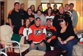  ?? SUBMITTED PHOTO ?? The late Rev. Augustine Esposito is pictured with his many nieces and nephews, all donning their Philadelph­ia Flyers gear. He administer­ed the sacraments to every one of his 12 nieces and nephews and also his 11 great-nieces and great-nephews.