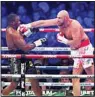  ?? ?? Britain’s Tyson Fury (right), lands a blow on Britain’s Dillian Whyte during their WBC heavyweigh­t title boxing fight at Wembley Stadium in London, on April 23. (AP)