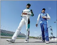  ?? COLIN E. BRALEY — THE ASSOCIATED PRESS ?? Chase Elliott, left, and Noah Gragson, right, walk to their cars before a practice run for a NASCAR Cup Series auto race at Kansas Speedway in Kansas City, Kan., Saturday, May 14, 2022.
