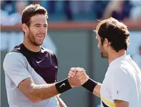 ??  ?? Juan Martin Del Potro (left) is congratula­ted by Roger Federer after their match on Sunday.