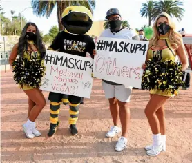  ?? Getty Images/denise Truscello ?? Facing facts: Participan­ts in the Mask Up for Nevada fashion show in Las Vegas, in the US, on June 25