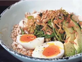  ??  ?? The Green Goddess bowl builds on barley with broccolini, shaved brussels sprouts, kale, avocado and a creamy boiled egg. Cashew cream, fried shallots and sunflower seeds give it extra flavor.