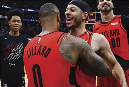  ??  ?? FROM FRONT: Portland Trail Blazers guard Damian Lillard celebrates with guard Seth Curry and center Enes Kanter after the second half of Game 7 of an NBA basketball second-round playoff series on Sunday, in Denver. AP PHOTO/JOHN LEYBA