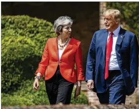  ?? DAN KITWOOD / GETTY IMAGES ?? British Prime Minister Theresa May and President Donald Trump get set to hold a
joint news conference Friday in Aylesbury, England. Earlier in the week, the British newspaper The Sun, revealed criticisms of May and her Brexit policy made by Trump in...