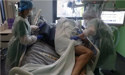  ?? ?? Medical staff treat a Covid-19 patient at an intensive care unit in Colmar, France. Photograph: Yves Herman/Reuters