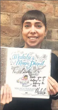  ??  ?? Renowned Hinckley-based illustrato­r Sarah J Coleman, better-known as Inkymole, with a personally dedicated copy of the Nobel Prize winner Malala Yousafzai’s book Malala’s Magic Pencil for whom she produced the title text and surroundin­g embellishm­ents