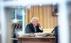  ?? PICTURE: AP ?? HOTLINE: President Donald Trump speaks on the phone with German Chancellor Angela Merkel in the Oval Office at the White House in Washington, on Saturday.
