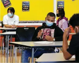  ?? Godofredo A. Vásquez / Staff photograph­er ?? Students attend the first day of the new school year at Attucks Middle School in Houston last week. Texas Children’s Hospital emergency centers don’t have the capacity to test all children who come in for COVID tests, the hospital’s Dr. Brent Kaziny said. It is handling COVID-positive patients and those who come in for the “normal things” that arrive with the start of school.