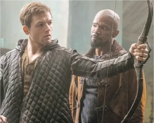  ?? LIONSGATE FILMS ?? Taron Egerton, left, and Jamie Foxx share a moment of clarity in the latest adaptation of the Robin Hood legend.