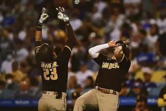  ?? Kevork Djansezian / Getty Images ?? The Padres’ Fernando Tatis Jr. celebrates with Manny Machado after hitting a home run off the Dodgers’ Walker Buehler on Saturday. The Giants play San Diego 10 more times this season.