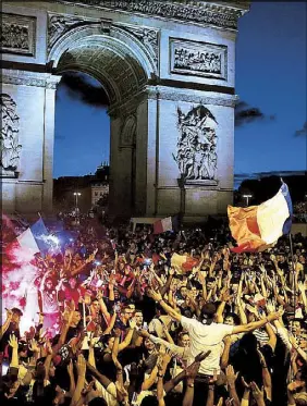  ?? AP ?? People celebrate on the Champs Elysees in Paris, with the Arc de Triomphe in the background, after France beat Belgium in the semifinal match of the 2018 World Cup yesterday. France advanced to the World Cup final for the first time since 2006. Story on Page 15.