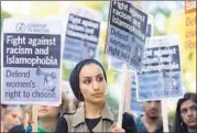  ?? AFP ?? A woman joins a demonstrat­ion organised by “Stand up to Racism” outside the French embassy in London on Friday.