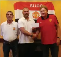  ??  ?? The Sligo Branch of the Manchester Utd Supporters Club held a raffle recently for the Northwest Hospice. 1st Prize winner Edward Cadman excepting cheque on behalf of his son Nathan from Eddie Gray and Maurice Langan.