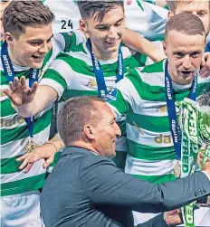  ?? Pictures: SNS. ?? Celtic captain Scott Brown, above, with the William Hill Scottish Cup at Hampden yesterday as he previewed today’s showpiece game. Brown has admitted that former manager Brendan Rodgers – pictured right handing the Scottish League Cup to Brown after beating Motherwell in the 2017-18 final – helped change the mindset at the club after his arrival three years ago.