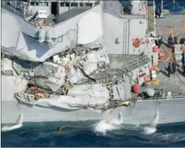 ?? ASSOCIATED PRESS ?? The damage of the right side of the USS Fitzgerald is seen off Shimoda, Shizuoka prefecture, Japan, after the Navy destroyer collided with a merchant ship, Saturday. Seven Navy sailors are missing and one was injured after the collision.