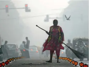  ??  ?? A street cleaner works in heavy smog in New Delhi yesterday. A thick blanket of grey air and pollutants has enveloped the Indian capital for four days.