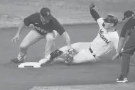  ?? LYNNE SLADKY/AP ?? The Marlins’ Corey Dickerson, right, is tagged out at second by Red Sox third baseman Christian Arroyo, left, during the first inning Wednesday in Miami.