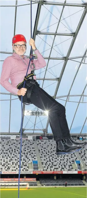  ?? PHOTO: STEPHEN JAQUIERY ?? Dropping in for money . . . University of Otago vicechance­llor Prof David Murdoch comes to a gentle stop following a 35m abseil from the roof of Forsyth Barr Stadium to the field below.