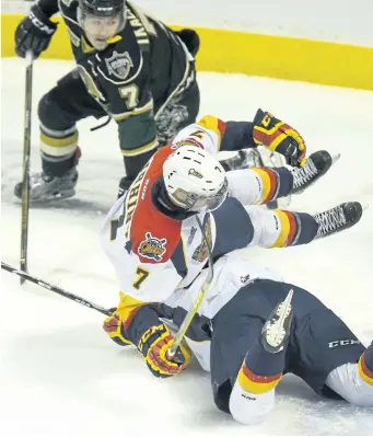  ?? SUPPLIED PHOTO ?? Erie Otters forward and Thorold native Christian Girhiny, No. 7, is upended by a teammate in Ontario Hockey League action against the London Knights in this file photo.