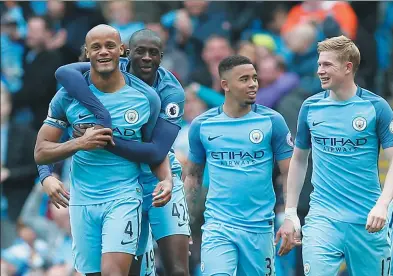  ?? ANDREW YATES / REUTERS ?? Vincent Kompany (left) is congratula­ted by Yaya Toure after scoring Manchester City’s second goal in Saturday’s 5-0 Premier League thrashing of Crystal Palace at Etihad Stadium in Manchester, England.