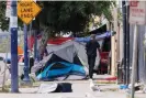  ?? ?? San Diego’s recently passed unsafe camping ordinance prohibits tent encampment­s in all public spaces throughout the city if shelter beds are available. Photograph: Mike Blake/Reuters