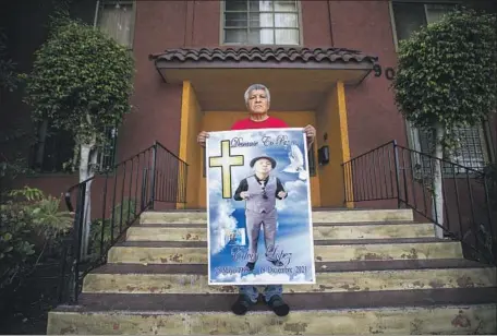  ?? Allen J. Schaben Los Angeles Times ?? MARGARITO Lopez holds a poster of son Margarito Jr., 22, who was holding a knife and in distress when LAPD officers killed him Dec. 18.