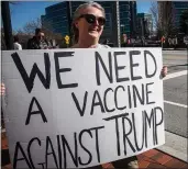  ?? RON HARRIS — THE ASSOCIATED PRESS ?? A protester holds a sign in front of the Centers for Disease Control and Prevention headquarte­rs on Friday.