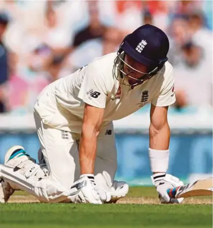  ?? REUTERS PIC ?? England’s Joe Denly crouches on the ground after he is hit by the ball during the match against Australia at the Oval in London yesterday.