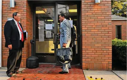  ?? Christian Abraham/Connecticu­t Post ?? Officials with the Federal Deposit Insurance Corp. outside The Community’s Bank headquarte­rs in Bridgeport, Connecticu­t, after the bank’s closure prompted an FDIC bailout for depositors.