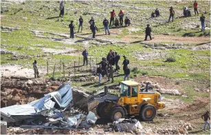  ?? (Wisam Hashlamoun/Flash90) ?? A BULLDOZER is used to demolish a shed in the West Bank village of Masafer in February 2020.