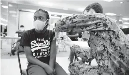  ?? JONATHON GRUENKE/STAFF FILE ?? Buka Okobi, 13, receives a Pfizer vaccine from Dalton Gilmore at Military Circle mall in May.