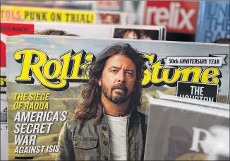  ?? JUSTIN SULLIVAN / GETTY IMAGES ?? A copy of Rolling Stone magazine is displayed on a shelf at Smoke Signals newsstand in San Francisco on Monday. The magazine’s controllin­g entity, Wenner Media, is selling its 51 percent stake in the rock music publicatio­n founded in 1967.