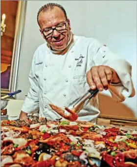  ?? T.R. LAZ ?? Chef Larry Schepici of Jack’s Oyster House in Albany tends to his station at a dinner and auction held June 19 at Franklin Terrace Ballroom in Troy to benefit the Jackie Baldwin Memorial Scholarshi­p.