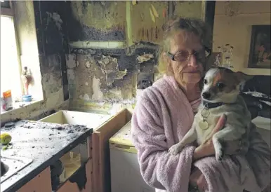  ??  ?? Sharon Carr, from Priest Avenue, with her dog Sparky, who she saved as fire took hold