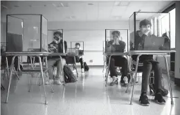  ?? JESSICA HILL/AP ?? The Centers for Disease Control and Prevention relaxed its guidelines for schools Friday, saying students can now sit 3 feet apart in classrooms. The new guidelines also remove recommenda­tions for plastic shields or other barriers between desks.