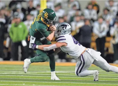  ?? ?? Kansas State linebacker Austin Moore (41) is one of several Wildcat defensive players returning for a super-senior fifth season in 2024.