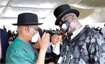  ??  ?? Rivers State Governor, Nyesom Wike ( right) and son of Chief Olu Bendon Lulu- Briggs, Dumo during his father’s burial in Abonnema, Rivers State… at the weekend