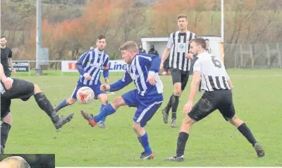  ?? LIBRARY PICS: Picasa; Richard Birch ?? ● No home comforts: Main, Mel McGinness (blue and white) got Holyhead’s leveller in their defeat to Guilsfield; left, Gary Taylor-Fletcher came closest for City in their ‘home’ loss to Ruthin Town