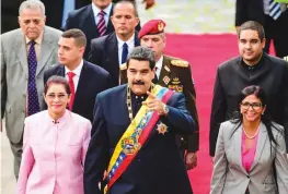  ?? — AFP ?? Venezuelan President Nicolas Maduro arrives at the Congress with his wife Cilia Flores (left), head of the Constituen­t Assemby Delcy Rodriguez (right) and others to address the new Assembly on Thursday.