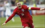  ?? THE ASSOCIATED PRESS FILE PHOTO ?? England’s Wayne Rooney celebrates his goal during the Euro 2016Group E qualifying soccer match between Slovenia and England, in Ljubljana, Slovenia. England striker Wayne Rooney announced his immediate retirement from internatio­nal football on Wednesday.