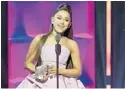  ?? MIKE COPPOLA/GETTY ?? Ariana Grande speaks onstage at Billboard’s Women In Music gala.