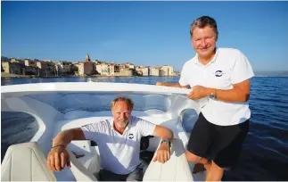  ??  ?? Anders Bringdal (left) and Alain Thebault, founders of French startup SeaBubbles pose aboard a prototype of their water taxi, in the harbour of Saint-Tropez, France. (Reuters)