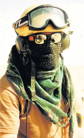  ??  ?? > A tank driver in the desert in the Iraq War in Janury 1991