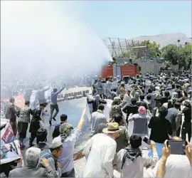  ?? Hedayatull­ah Amid European Pressphoto Agency ?? SECURITY forces use a water cannon on a crowd protesting this week’s massive suicide bombing in Kabul. Presidenti­al palace guards reportedly shot at the crowd.