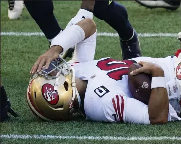  ?? ELAINE THOMPSON — THE ASSOCIATED PRESS ?? 49ers quarterbac­k Jimmy Garoppolo reacts after he was sacked by Seahawks middle linebacker Bobby Wagner during the first half on Nov. 1, in Seattle.