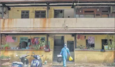  ?? PTI ?? A health worker leaves a residentia­l area after conducting swab tests for Covid-19 following rise in Covid cases at Dharavi.