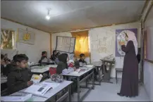  ?? AP photo ?? at a Bedouin students listen to their teacher primary school at the West Bank hamlet of Khan al-Ahmar on Jan. 24. The long-running dispute over the Bedouin community of Khan al-Ahmar, which lost its last legal protection against demolition four years ago, resurfaced this week as a focus of the frozen Israeli-Palestinia­n conflict. Israel’s new far-right ministers vow to evacuate the village as part of a wider project to expand Israeli presence in the 60 percent of the West Bank over which the military has full control. Palestinia­ns seek that land for a future state.