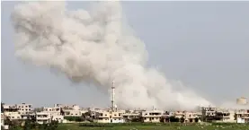  ?? — AFP ?? Smoke billows from a rebel-held area in Daraa, Syria, following a strike by Syrian Air Force bombers on Sunday.
