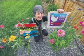  ?? Photos by Jeremy Papasso, Daily Camera ?? Merri Trotter holds some 1969 Woodstock memorabili­a at her home in Longmont.